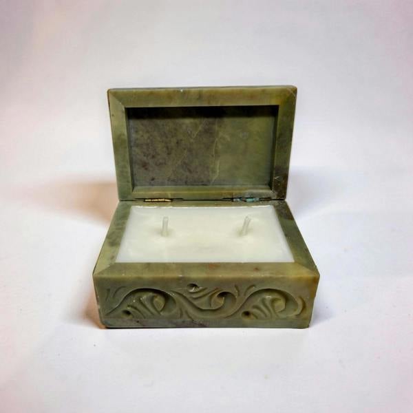 Decorative box with a candle inside on a white background