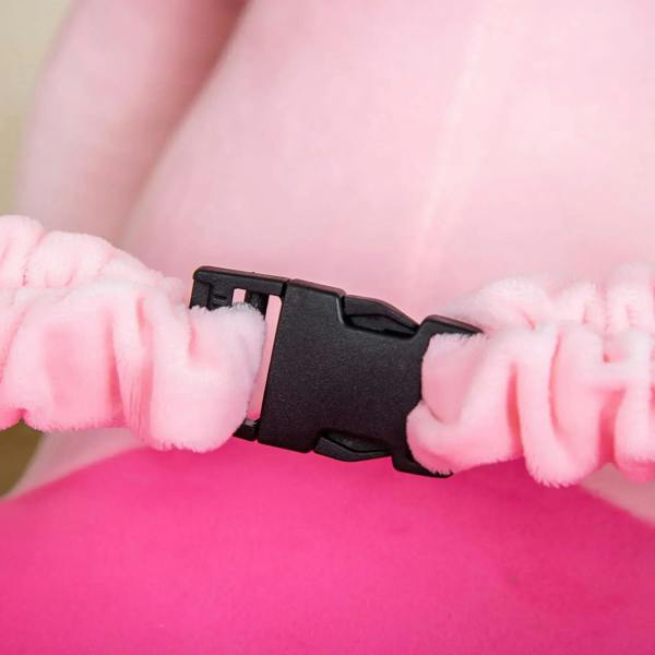 Pink plush seat with black seat-belt latch connector on ride-on toy