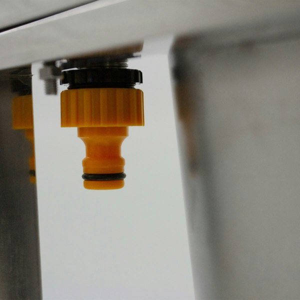 Portable stainless steel camping sink featuring a yellow water connector, showcasing durable construction and practical design