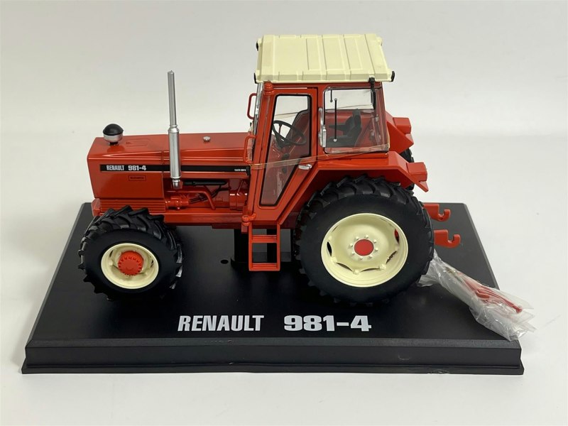 a red tractor on a black stand