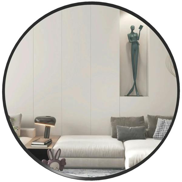 Round black wall mirror with a thin frame, reflecting a living room seating area