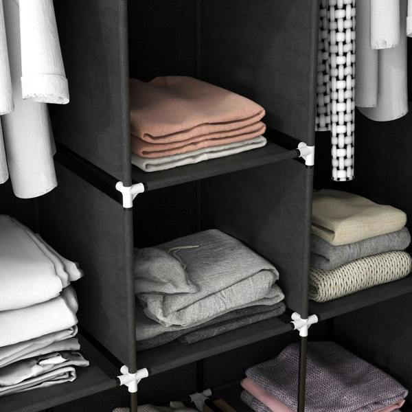 Black fabric wardrobe shelf with stacked folded towels and fabric items.