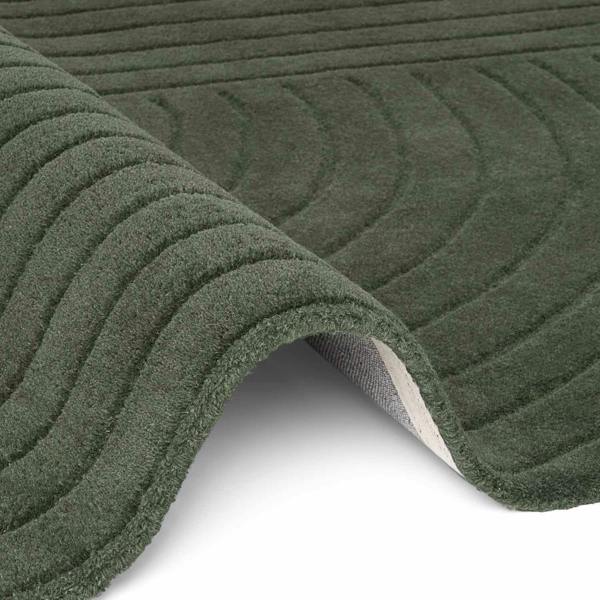 Close-up of green textured rug with patterned surface