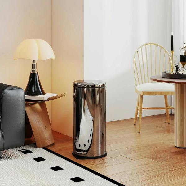 Polished silver stainless step trash can with black pedal and round top lid