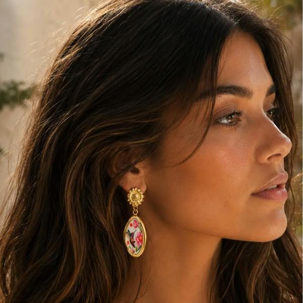 Close-up of a woman wearing floral earrings outdoors