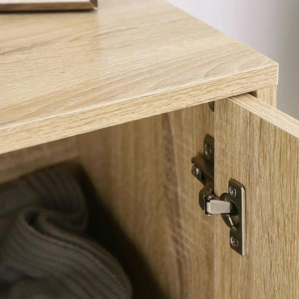 Oak cabinet door hinge and latch with dark metal hardware