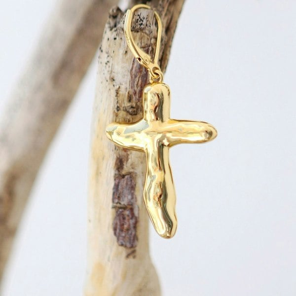 Gold vermeil cross earring on a branch.