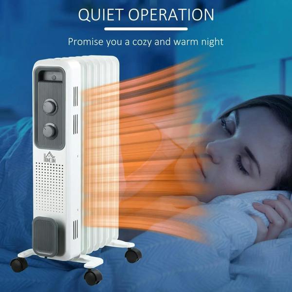 White oil-filled radiator heater beside bed with control panel and side vent grille
