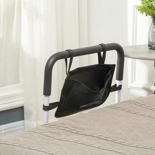 White bed rail with black storage pocket and curved black handle, bedside angle