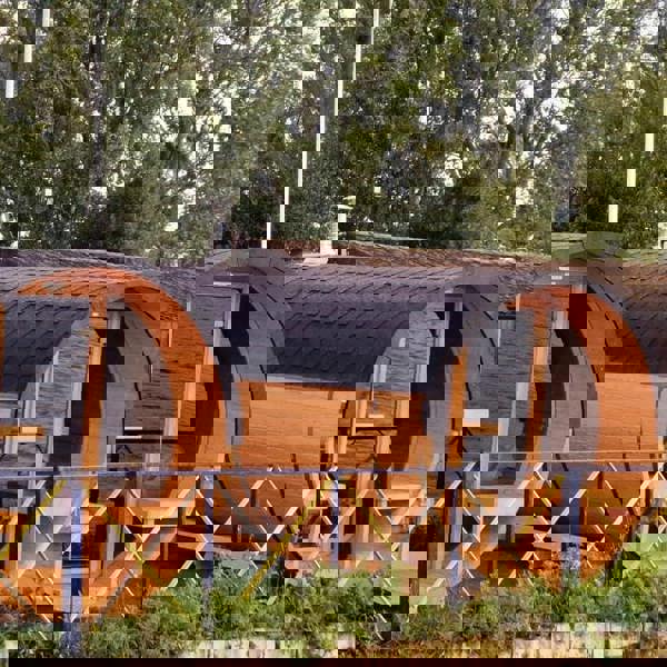 Barrel-shaped cabins near water