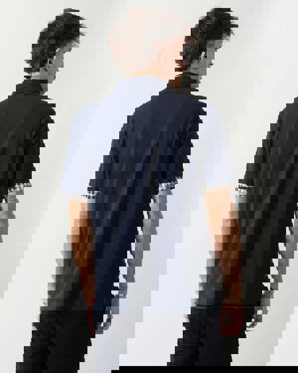 back shot of a model wearing an Aquascutum Mens Club Check Stretch Piquet Sleeves Polo Shirt in Navy 11