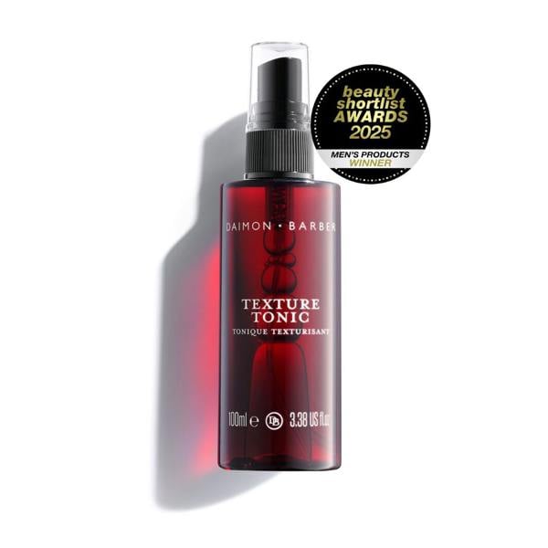 A red spray bottle labeled 'Texture Tonic' by Daimon Barber, designed for hair styling, with an award seal stating 'beauty shortlist awards 2020 Men's products'.
