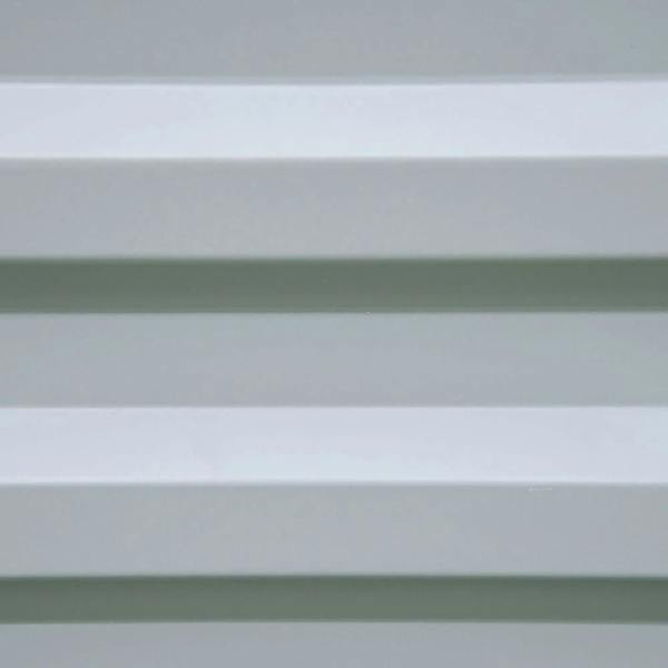 Grey raised planter bed wall with horizontal slat panels, close-up