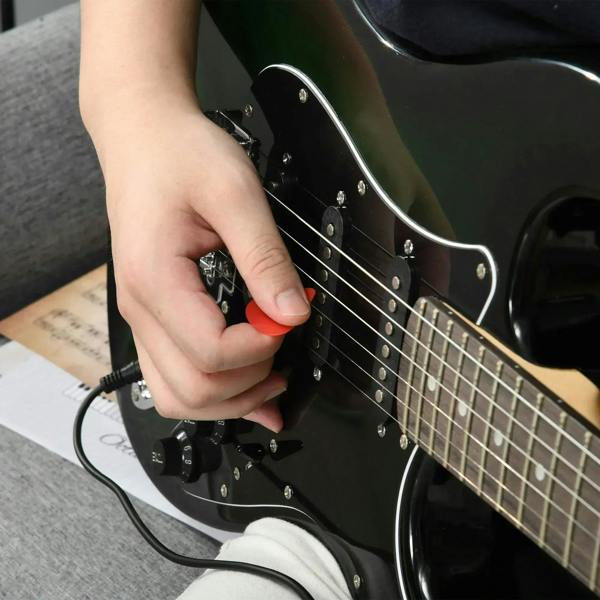 Electric guitar close-up with connected cable at output jack, dark finish body