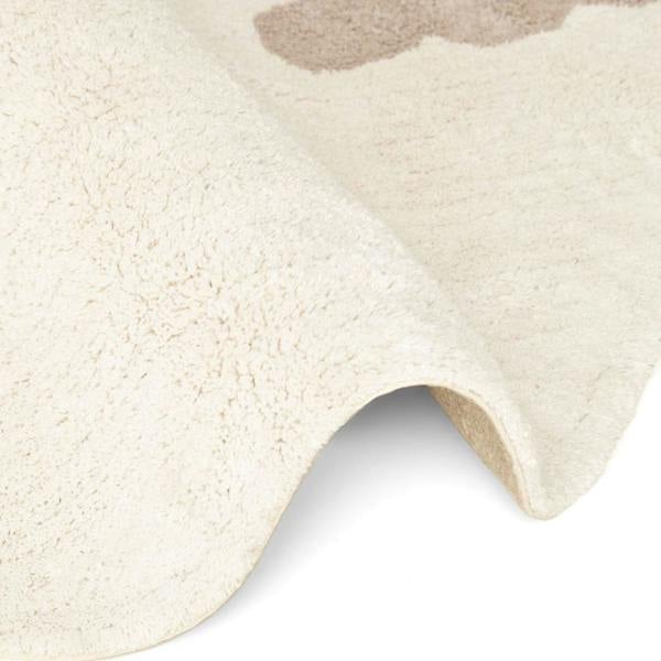 Close-up of a textured beige rug with a soft, plush surface.