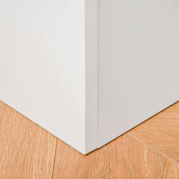 White toy box corner detail with light wood base and clean seam on the bottom edge