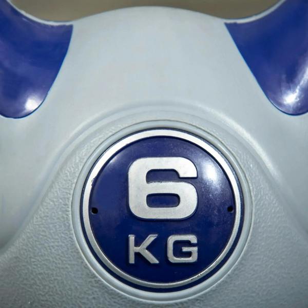 6 kg kettlebell close-up of round weight badge on grey body with purple handle