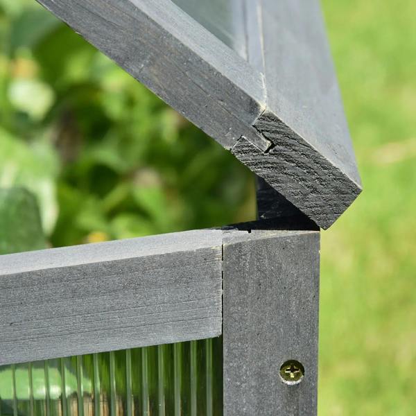 Grey cold frame greenhouse corner joint with screw fastener and clear polycarbonate wall