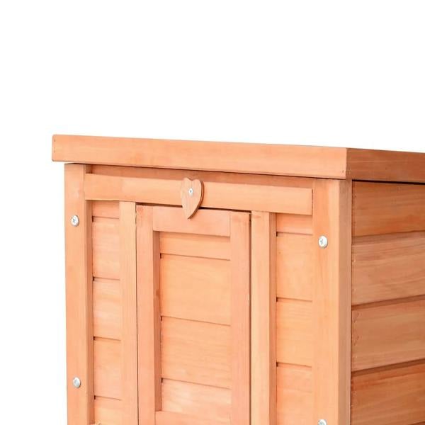 Close-up of wooden hutch front door with heart-shaped latch, natural finish