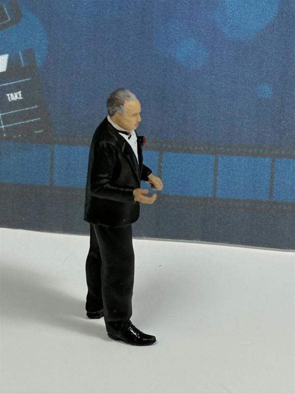a toy figurine of a man in a tuxedo