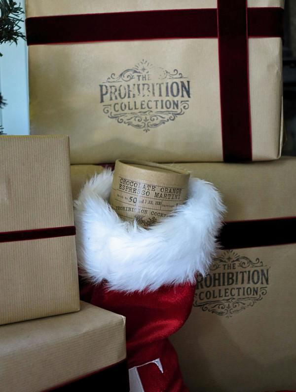 A chocolate orange espresso martini bauble box, displayed among wrapped gift boxes printed with 'The Prohibition Collection.'.