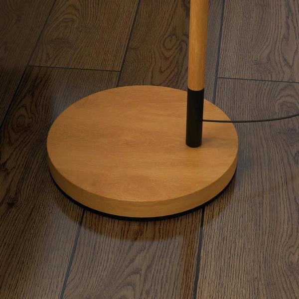 Round brown lamp base with black center pole band on wood floor