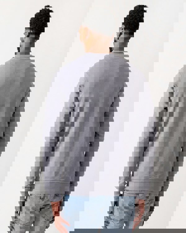 back shot of a Model wearing a Belstaff Mens Crew Neck Sweatshirt With Logo Patch in Faded Indigo