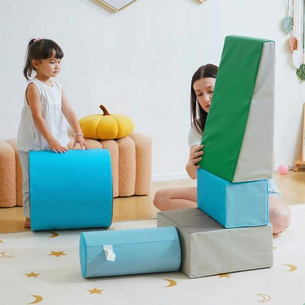 Kids lifting blue-and-green foam play set pieces: cube, tunnel, and ramp