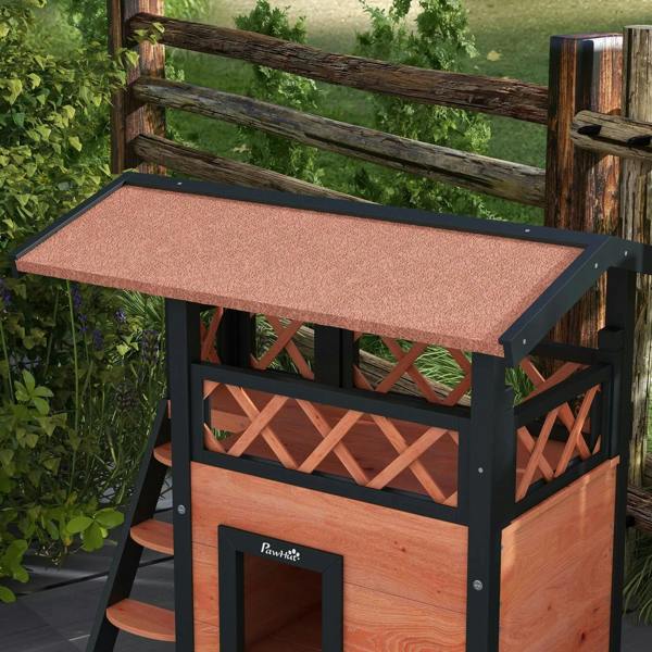 Outdoor cat house with sloped roof and balcony railing; brown wood front door