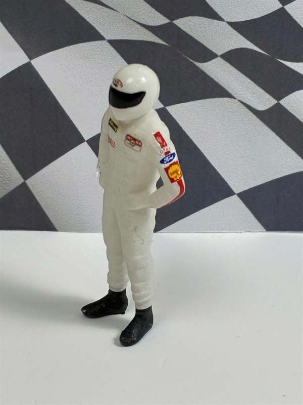 a toy figure of a race car driver