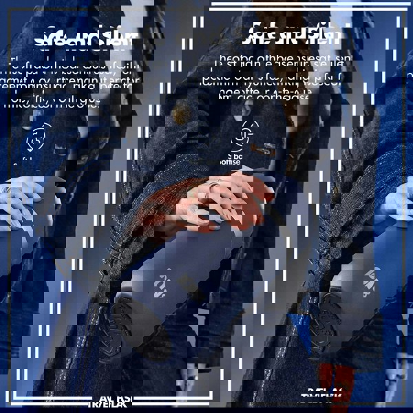 A person holds a blue travel flask with a soft base while wearing a denim jacket against a blue background. Text: Safe and Silent The soft pad on the base ensures safe silent placement on any surface making it perfect for home office or on-the-go use. Soft base TRAVEL FLASK ION8.