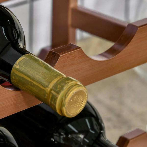 Close-up of a wine bottle resting in a brown bamboo curved slot holder