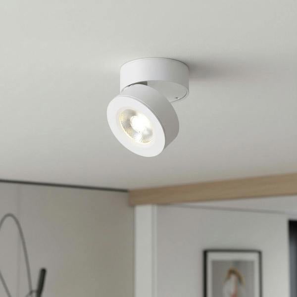 white adjustable ceiling light mounted on a white ceiling in a modern home