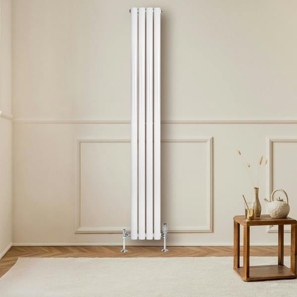 Sleek white oval single column radiator, 1800 x 240mm, mounted on a wall, complementing a cozy living space with wooden accents