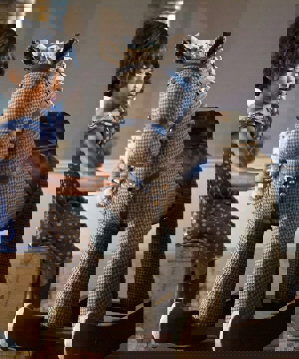 Little girl playing with Chester & Fred Rocking Hrse with luxury hounds tooth fabric