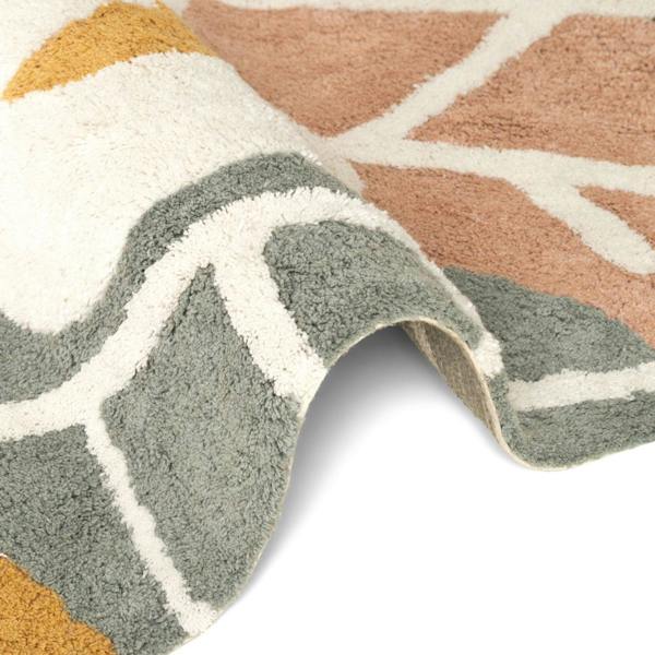 Close-up of a patterned rug with geometric design on a white background