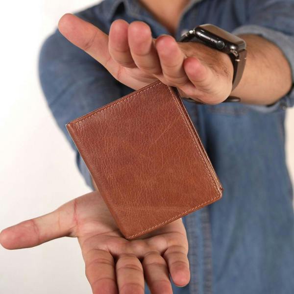 Person holding tan leather wallet for men nico tuscan