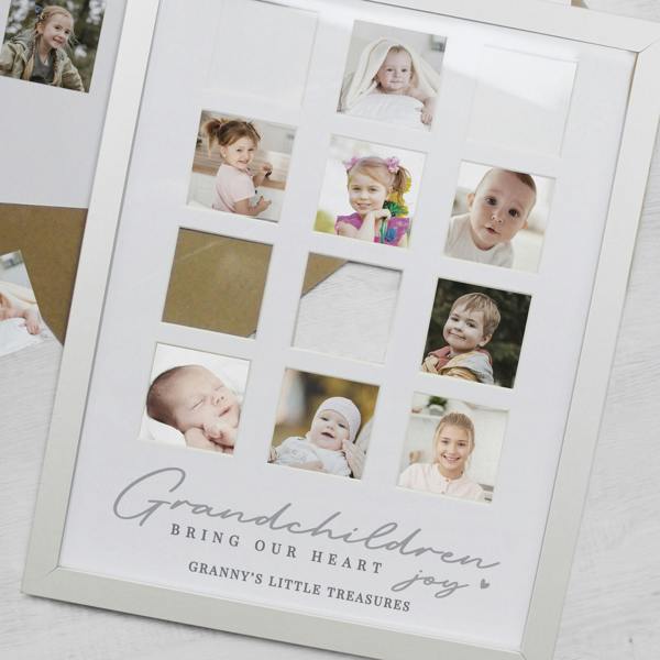 An angled, close-up shot of a white multi-aperture frame being filled with grandchildren's photos, showing the custom printed text Granny's Little Treasures.