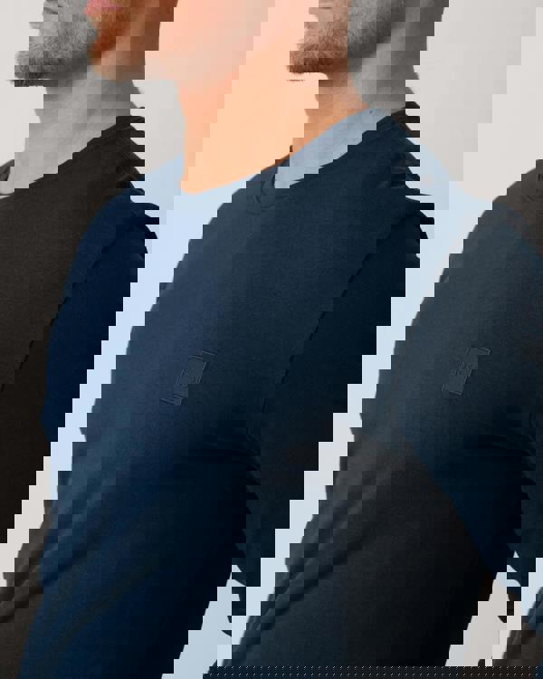 Model wearing BOSS Orange Tacks Mens Long Sleeve T-Shirt in Open Blue 464 - Patch Detail