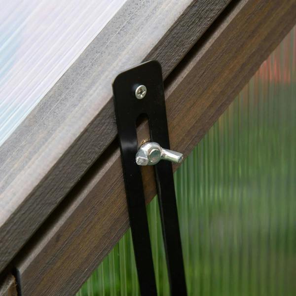 Black latch on wooden cold frame greenhouse with metal handle
