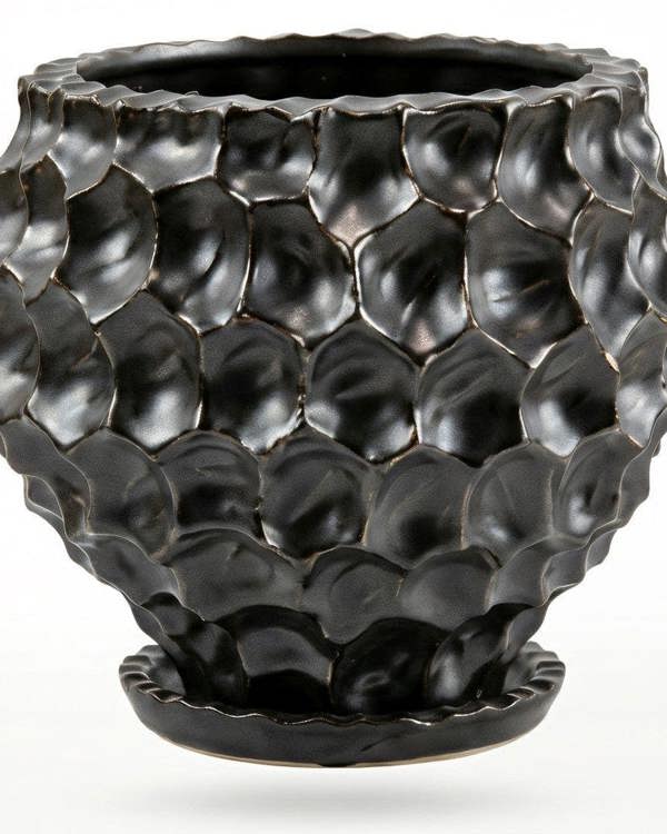 Black textured vase on a white background