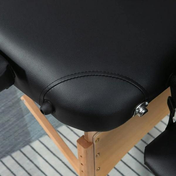 Black padded armrest end with stitched cushioning and rounded edge on wooden frame