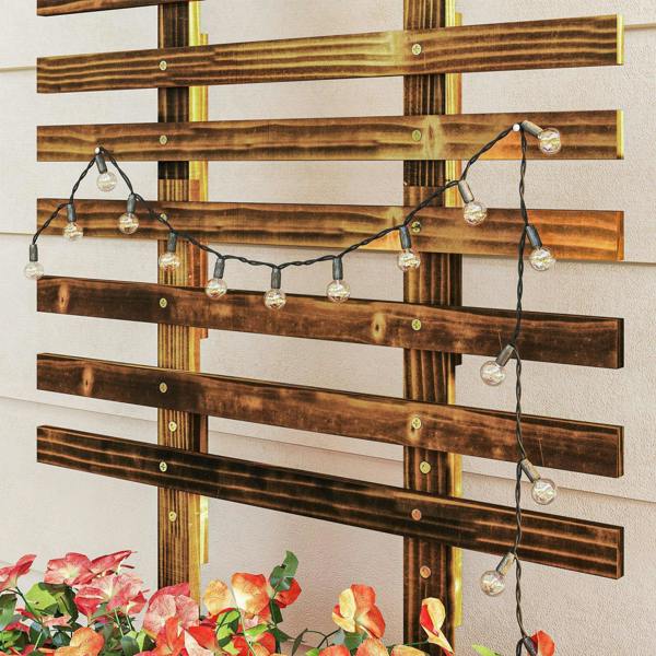 Carbonised wooden lattice trellis with hanging string lights