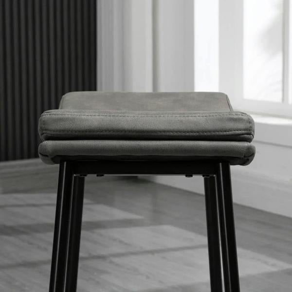 Grey padded bar stool seat with stitched edge and black steel legs