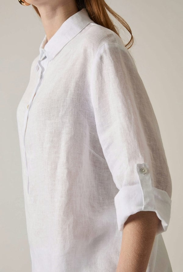 White linen blouse with button front and roll tabs