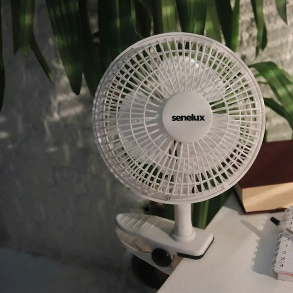 A photo of the clip on fan clipped to a desk