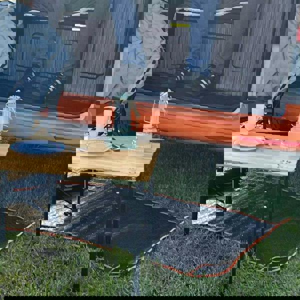 Awning Tunnel Mat 1500mm x 800mm Black Rubber with Orange Edge Trim being used within a campervan awning tunnel.