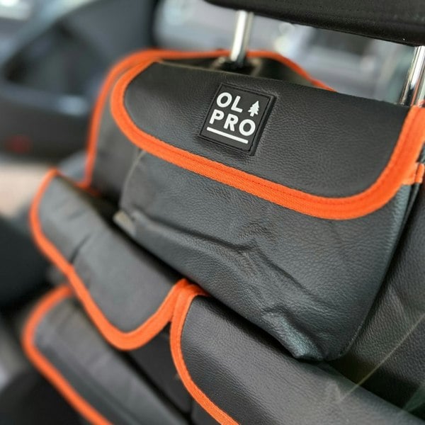 The Rear Single Seat Storage Organiser in Orange by OLPRO attached to the front drivers seat of a VW vehicle.