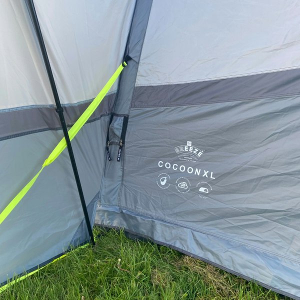 The Cocoon Breeze® XL v2 Motorhome Awning (Grey) from OLPRO pictured in a campsite showing a closeup of the logos included on the Cocoon Breeze XL v2.