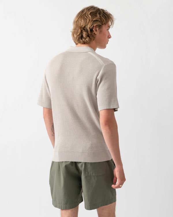 back shot of a Model wearing a BOSS Orange Aravolo Mens Short Sleeve Knit Polo Shirt in Open Grey 070